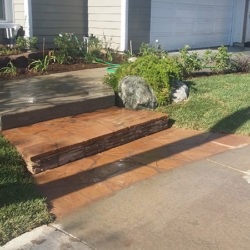 A brick walkway with steps leading to the front door.