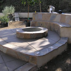 A fire pit sitting in the middle of a patio.