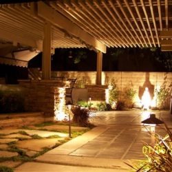 A patio with lights and a fire place