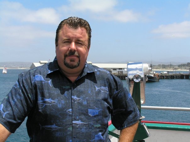 A man standing on the deck of a boat.