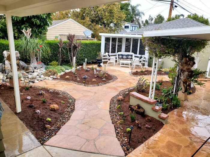 A garden with a bench and a gazebo